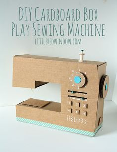 a cardboard sewing machine sitting on top of a table