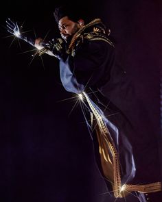 a man dressed in black performing on stage