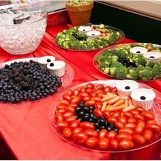 a table topped with lots of different types of vegetables and fruit on plates next to each other