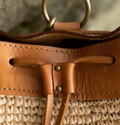 Ideal for any adventure and perfect for days spent on a plane or the beach, The Transito Backpack is a catch-all that’s up for everything you are. It has adjustable leather straps and a cinching leather top to secure your goods but still allow you convenient access. Handmade by skilled artisans and woven from an all-natural, plant-dyed cactus fiber and high-quality, vegetable-tanned leather. Style Notes Adjustable, removable straps Size: H 12" x L 9.5" x W 9" Large enough to hold all the essenti Leather Vacation Bag With Leather Handles, Leather Bucket Bag With Detachable Strap For Travel, Leather Bag With Leather Handles For Vacation, Travel Shoulder Bag With Leather Trim In Natural Color, Vacation Leather Shoulder Bag With Leather Trim, Natural Leather Trim Shoulder Bag For Travel, Natural Shoulder Bag With Leather Trim For Travel, Casual Leather Backpack With Adjustable Strap For Travel, Adjustable Bags With Leather Trim For Everyday Use