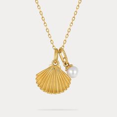 This delicate pearl and gold shell pendant necklace speaks volumes on sustainable style.  Featuring a genuine freshwater pearl nestled within a 9k gold-plated shell, this dainty necklace captures the ocean's essence in an eco-friendly design. Perfect for the conscious consumer, this necklace adds a touch of delicate charm and aquatic inspiration to any outfit. 🌊 DETAILS Plating: 9K Gold  Materials: 9K Gold on Silver, Freshwater Pearl Measurements: Length: 15.75 "(40cm) + Extender: 1.97"(5cm) Pendant Size: 0.47"*0.71"(1.2cm*1.8cm) Weight: 3.1 g Yellow Gold Charm Necklace With Pearl Drop, Elegant Gold Shell Necklace With Pearl Charm, Elegant Pearl Necklace With Shell Pendant, Elegant Shell Shaped Pearl Chain Necklace, Elegant Gold Shell Necklace With Pearl Pendant, Elegant Gold Shell Necklace With Pearl Drop, Pearl Charm Pendant Shell As Gift, Elegant Gold Shell-shaped Necklace, Yellow Gold Charm Necklace With Pearl Pendant