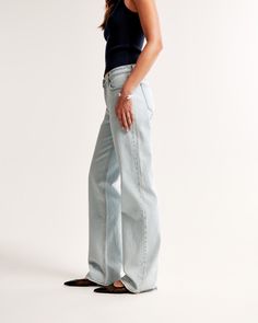 Our classic low rise baggy jeans in a light wash with a clean hem. This fit features a 8.5” low rise, is slightly relaxed at waist and hips, and eases at the thigh into a baggy, full-length leg shape. We recommend buying your true size for a baggier fit. Size down for a closer fit. This jean is made from our vintage stretch fabric which features both an authentic vintage look and contains slight built-in stretch for additional comfort. Low Rise Baggy Jeans, Baggy Jean, Women's Bottoms, Closet Size, Modern Trend, Low Rise Jeans, Pocket Bag, Sleek Look, Baggy Jeans