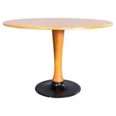 a round wooden table with black pedestals and an oval wood top, on a white background