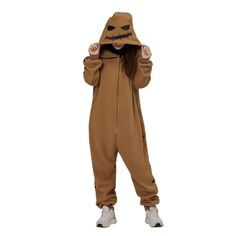 a person wearing a brown costume with a mask on their head and hands in the air