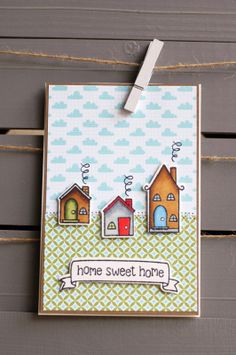 a card with some houses on it and a paper clip hanging from the front of it