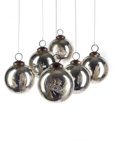 six silver ornaments hanging from strings on a white background