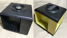 two black and yellow speakers sitting on top of a bed