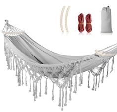 a white hammock with red pillows and accessories