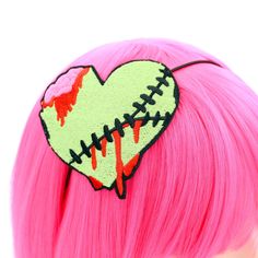 Introducing our Bleeding Zombie Heart Embroidered Headband, a frightfully chic accessory that combines gruesome elegance with ghoulish flair. This headband is perfect for those seeking to celebrate their love for all things horror, and make a wickedly bold fashion statement. Crafted with meticulous attention to detail, our Bleeding Zombie Heart Headband features an embroidered heart design that truly brings the undead to life. The heart itself is adorned in a vibrant lime green hue, radiating an Zombie Accessories, Heart Headband, Zombie Dolls, Horror Lovers, Kawaii Hairstyles, Embroidered Heart, Creatures Of The Night, Chic Accessories, Fete Halloween