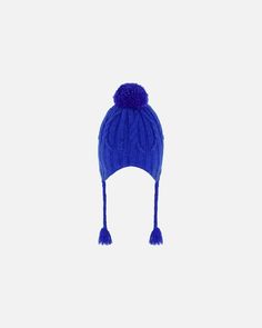 Detailed with a cozy lining, our Peruvian Knit Hat Royal Blue puts the perfect finishing touch on any cold weather look. This adorable winter hat features a chunky cable knit texture with earflaps, a fluffy pompom on top, and braided tassels that hang on each side. Team with a matching neckwarmer for added warmth and total coordination! Earflap hat Pompom Braided tassels 58% Acrylic,15% Nylon, 27% PBT - Lining: 94% Polyester, 6% Elastane Fits true to size From 2 years to 16 years Blue Crochet Hat For Cold Weather, Blue Hand Knitted Beanie For Winter, Winter Blue Hand Knitted Beanie, Blue Winter Bonnet Hat, Braided Tassels, Chunky Cable Knit, Knit Texture, Dress Gift, Knit Hat