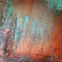 rusted metal with blue and red paint on it