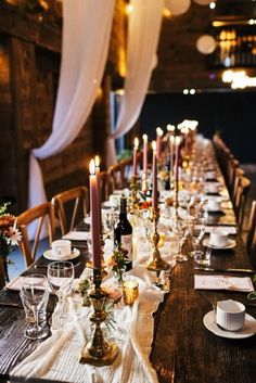 a long table with candles and place settings