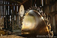 there is a large metal object in the middle of a room with many clocks on it