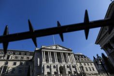 the bank of england building is seen through a fence