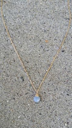 "A simple tiny blue opal stone suspended from a delicate gold filled or sterling silver chain. Perfect for adding a touch of color to any layered ensemble. The stone is a tiny 7mm and a beautiful opaque periwinkle blue color. It matches everything! Shown here in 16\" length. *If you are unsure of the length you need, or would like to wear this item at different lengths, we now offer an adjustable length option! You can add an adjustable end to your necklace using this link: https://www.etsy.com/ Dainty Blue Moonstone Jewelry, Minimalist Opal Jewelry With Delicate Chain, Gold Chalcedony Jewelry As A Gift, Everyday Gold Opal Jewelry, Dainty Blue Birthstone Necklace For Everyday, Simple Blue Everyday Jewelry, Dainty Blue Charm Necklace For Everyday, Blue Opal Dainty Necklace, Blue Dainty 14k Gold-filled Jewelry