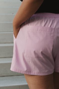 a woman wearing pink shorts and black shirt