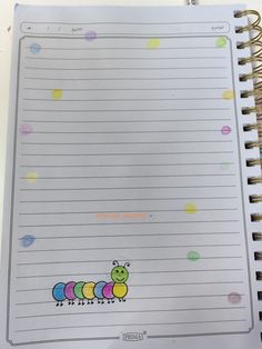 a spiral notebook with the caterpillar on it