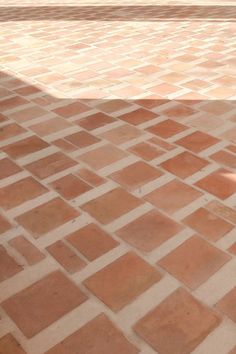 a man riding a skateboard on top of a brick walkway