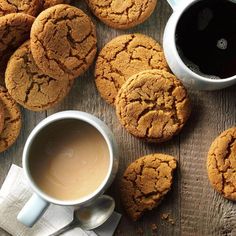 several cookies and two cups of coffee on a table