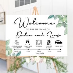 a welcome sign for the wedding of blue and tan, with greenery on it