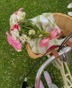 a basket filled with flowers sitting on top of a bike