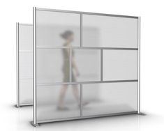 a person standing in front of a white wall with glass panels on the sides and bottom