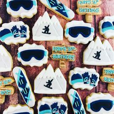 decorated cookies with ski and snowboard images on them are arranged in the shape of mountains