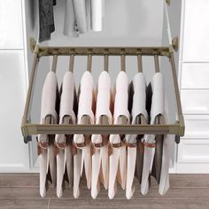 a rack with several pairs of shoes hanging on it