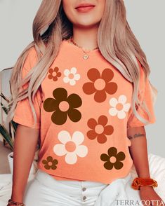 🍄 Retro daisy aesthetic tee by TheCocoBear 🍄 With its groovy colors and oversized flowers, you can embrace your inner flower child whether you're on your coffee run, having a picnic in the park, or lounging by the beach 🍄 Comfort Colors brand, garment-dyed 100% ringspun cotton 🍄To ensure sizing, refer to size chart in photos and compare measurements to those of a shirt you already own that fits well. 🍄 Non-toxic, eco-friendly, water-based inks safer for you & the environment. 🍄 The Comfort Oversized Floral Print T-shirt For Spring, Cute Oversized T-shirt For Spring, Retro Orange T-shirt For Spring, Oversized Cute Spring T-shirt, Cute Oversized Spring T-shirt, Trendy Oversized Floral Print Tops, Orange Graphic Tee For Spring, Cute Daisy Print Tops For Spring, Retro Floral Print Crew Neck Tops