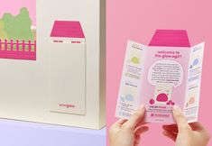 someone is holding up a pink and white brochure