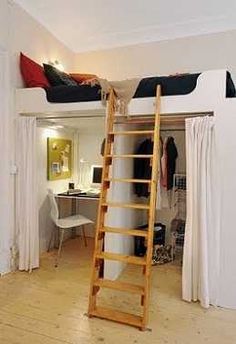 there is a ladder in the middle of this room that leads to a loft bed