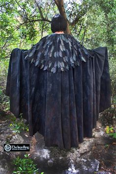 the back of a man's cape with feathers on it