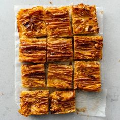 there are many pieces of food on the paper towel that is cut into squares and placed on top of each other