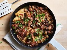 a pan filled with food sitting on top of a wooden table