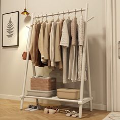 a white coat rack with clothes and shoes on it next to an open closet door