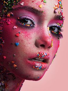 a woman with sprinkles all over her face and body is looking at the camera