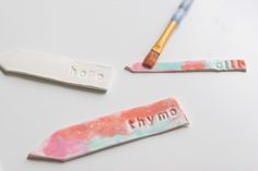 three different colored toothbrushes with the word hyvine on one end and an acrylic brush on the other