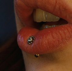 a close up of a person's lip with a nose ring on it,