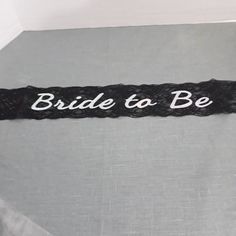 the bride to be sash is black and white