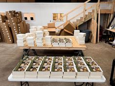 several stacks of boxes sitting on top of a table in front of stairs and steps