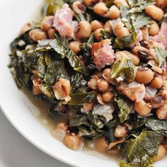 a white plate topped with beans and greens