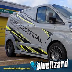 an electric vehicle parked in front of a building with the words blue lizard on it