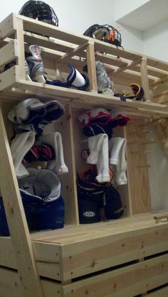 a wooden shelf with several pairs of shoes on the top and bottom shelves above it