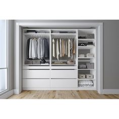 an open white closet with clothes hanging on the doors and shelves in front of it