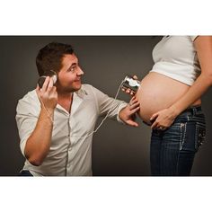 a pregnant man is listening to the radio