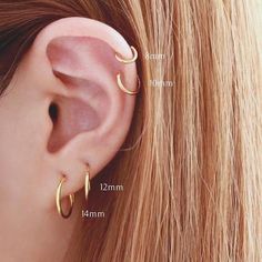 an ear with two different types of piercings on the side and one in front