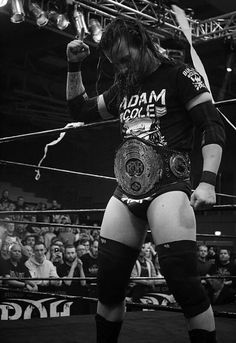 a man standing on top of a wrestling ring