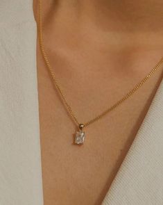 Simple, graceful, and minimalistic, this piece features a rectangular clear crystal CZ stone suspended on the daintiest gold chain. Made with 100% gold-filled materials, she is truly an everyday necklace that you can wear whenever and wherever your heard desires — even in the shower. …………………………………. D E T A I L S • Pendant measures 5 x 13 mm • Tarnish-resistant, waterproof, safe for sensitive skin • 1.5mm width curb chain with spring clasp • 100% 18k gold-filled Timeless Rectangular Pendant Jewelry As Gift, Timeless Rectangular Pendant Jewelry Gift, Tarnish Resistant Necklace With Rectangular Pendant, Elegant Charm Necklace With Square Pendant And Adjustable Chain, Elegant Necklace With Adjustable Chain And Square Pendant, Elegant Necklace With Square Pendant And Adjustable Chain, Chic Necklace With Rectangular Pendant For Gift, Classic White Necklace With Rectangular Pendant, Minimalist Formal Jewelry With Rectangular Pendant