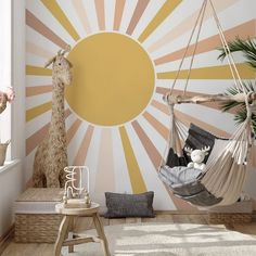 a child's room with a hammock and giraffe on the wall