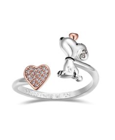 a silver and gold ring with a dog on it's side, in the shape of a heart